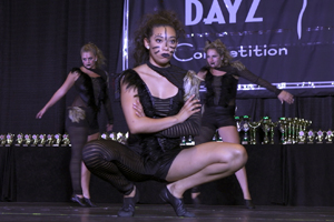 Dancers in cat outfits on stage at competition